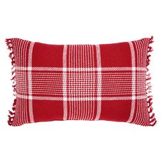 a red and white plaid pillow with fringes