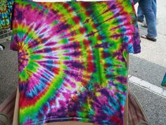 a tie - dyed t - shirt is sitting on a cart