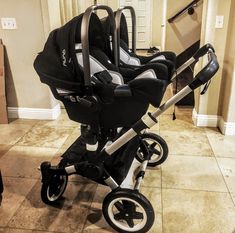 two baby strollers are sitting on the floor