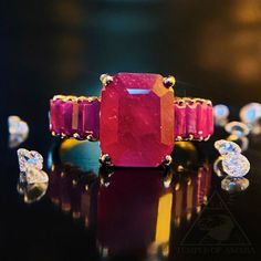 SAME DAY SHIPPING!!! Imagine a forbidden ruby plucked from the cave of wonders or a ring fit for an ancient priestess or queen! The Burmese rubies in this ring are absolutely gorgeous! Made of solid 10k yellow gold, this ring houses 9 emerald cut natural rubies. Such a sultry, sexy, powerful Luxury Red Rectangular Ruby Ring, Luxury Red Pink Sapphire Ring, Elegant Emerald-cut Lab-created Ruby Jewelry, Red Emerald-cut Fine Jewelry, Turquoise Diamond Earrings, Luxury Red Tourmaline Jewelry