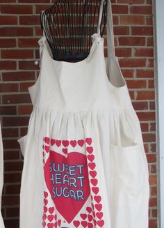 "Pinafore, Womens jumper, SZ 2x, Feed Sack jumper, Sweet heart sugar, jumper, prairie dress, farmhouse clothing, country, french country. Prairie Pinafore. Wear it with a T-shirt, or denim shirt, or layer with pantaloons. * Feed Sack design: Red Sweet Heart Sugar, pure and natural, Jefferson Tx * Colors: Natural cream feed sack with, Red and blue ink sugar sack print. * Scoop neck with shoulder ties. * Approximately women Medium/ Long length, prairie style jumper. * Style: french country, Prairi Apron Sewing, Apron Sewing Pattern, Feedsack Fabric, Jumper Style, Sewing Aprons, Gingerbread Girl, Country French, Prairie Style, Natural Cream