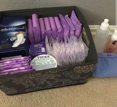 an open suitcase filled with lots of purple items on top of a carpeted floor