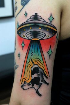 an alien ship flying through the sky with a cow under it's arm tattoo