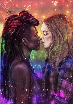 two women kissing each other in front of colorful lights and sparkles on the background