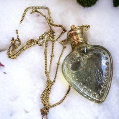 The Mirall Bruja's potion necklace allows you to choose from any of our charming victorian eau de toilette perfumes. The perfume is poured inside a beautiful glass heart amulet. This darling pendant hangs from a 26" (70 cm) gold steel chain with lobster clasp closure. The bottle measures 46mm x 33mm (1.8 inches x 1.3 inches).  Great for travel- to apply, gently dab a small amount of perfume to pulse points as often as you fancy. Contains 4ml of perfume. The perfume is poured inside a beautiful g Perfume Necklace Pendants, Heart Amulet, Potion Necklace, Perfume Necklace, Pink Guava, Organic Perfume, Earth Goddess, Pulse Points, Perfume Gift