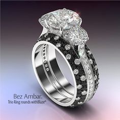 two wedding rings with black and white diamonds on each band, set in 18k white gold