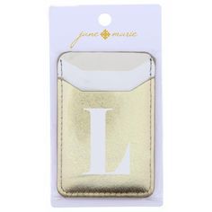 the letter k in gold foil on a white card holder