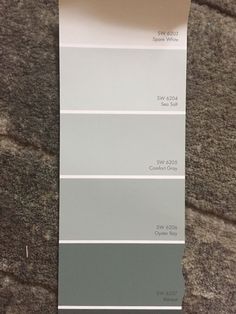 a pantone color swatch with different shades of gray and white on it, sitting on the floor