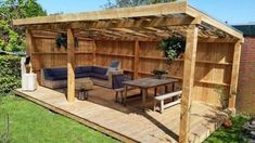 an outdoor living area with couches and tables