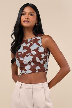 Effortlessly collect compliments everywhere you go in the Lulus Coveted Essence Brown Floral Mesh Cutout Tie-Back Crop Tank Top! A bold blue floral print adorns stretchy mesh knit as it shapes this flirty top with a crew neckline and a sleeveless, princess-seamed bodice. Perfectly cropped hem features sash ties that secure at the back below an alluring cutout and a surplice-style design. Fit: This garment fits true to size. Length: Size medium measures 16.00" from shoulder to hem. Bust: Great fo Brown Floral Print Tops For Beach, Fitted Floral Print Tops For Vacation, Fitted Blue Tops With Tropical Print, Printed Crop Top, Flirty Tops, Crop Tank Top, Blue Floral Print, Print Crop Tops, Brown Floral