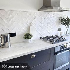 a stove top oven sitting inside of a kitchen next to a wall mounted range hood