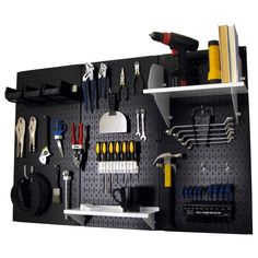 a peg board with various tools hanging on it's wall and some shelves below