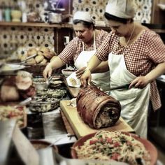 two women are preparing food in a kitchen