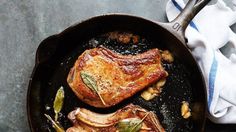 two pieces of meat in a skillet on a table