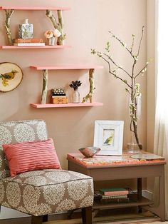 a living room with pink walls and shelves filled with books, vases and flowers