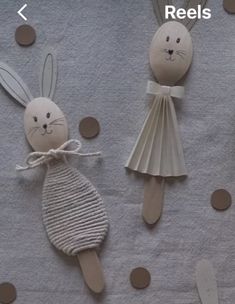 three wooden spoons with bunny and rabbit decorations on them