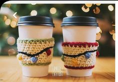 two coffee cups sitting next to each other on a table