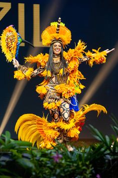 a woman dressed as a dancer with yellow feathers