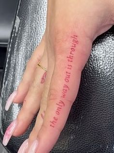 a woman's hand with a small tattoo on her left thumb and the words, you