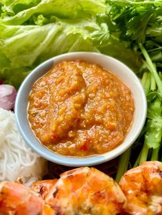 grilled shrimp, lettuce and tomato sauce on a plate with white rice