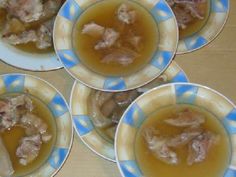 four blue and white plates filled with soup