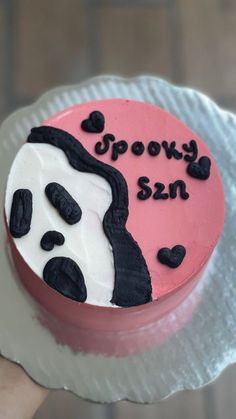 a cake with black and white frosting that says spooky skin on it