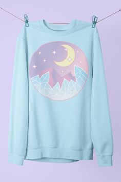 Check out my cute high vibration vaporware pastel crystal sweater. Can be printed on hoodies or t-shirts! Perfect vacation or beach wear gift for those that love soft aesthetic clothing. This soft sweatshirt has a loose fit for a comfortable feel. With durable print, it will be a walking billboard for years to come. .: Loose fit .: 50% Cotton; 50% Polyester (fibre content may vary for different colors) .: Medium fabric (8.0 oz/yd² (271.25 g/m .: Sewn in label .: Runs true to size 100% No Sweatsh Kawaii Vaporwave, Pastel Clothes, Moon Sweater, Pastel Clothing, Style Dr Martens, Goth Harajuku, Kawaii Sweatshirt, Aesthetic Fairy, Kawaii Pastel Goth