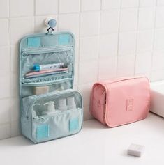 two toiletries bags sitting next to each other on a bathroom counter with white tiles