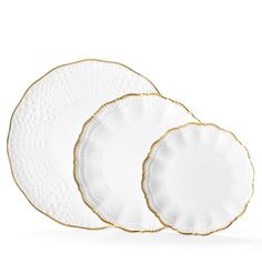 three white and gold dinner plates