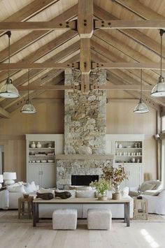 a living room filled with lots of furniture and a fire place in the middle of it