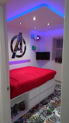 a bedroom with a red bed and avengers wall decals