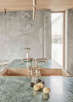 a kitchen with marble counter tops and stainless steel faucets