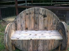 a wooden bench made out of old pallets with writing on the back and sides