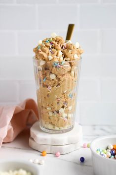 an ice cream sundae with sprinkles and chocolate chip cookies in it