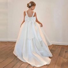 Elevate your little one's special occasion with our Dreamy Vow Elegant White Flower Girl Dress. Made with silky satin and a delicately placed bow, this ball gown radiates sophistication. Perfect for weddings, birthdays, and first communions. Available in sizes 2024 J205.