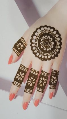 a henna tattoo on the palm of a woman's hand