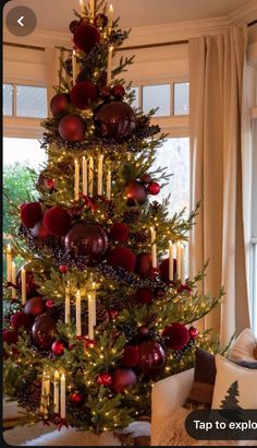 a christmas tree decorated with candles and ornaments