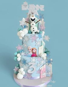 a frozen princess birthday cake on a blue background