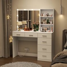 a white vanity with lights on it in a bedroom next to a bed and window