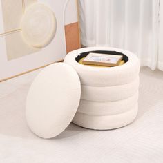 a stack of white round cushions sitting on top of a bed