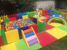 an inflatable play area with colorful foam balls and plastic blocks on the ground