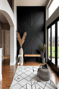 Chic entryway with black board and batten accent wall, wooden bench, and decorative plants. Entryway House Ideas, Wall Accents Ideas, Modern House Wall Design, Building Decorations Ideas, Long Interior Wall Design, Black Picture Ledge Ideas, Half Wall Accent Ideas Living Room, Entryway Wall Design Ideas, Wall Style Ideas