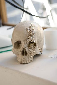 a white skull sitting on top of a table