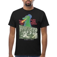 Dragon Mountain Bob Hope Shirt This Vietnam War t-shirt is painted by Marty. It depicts the true story of one hot day in 1967, outside of Pleiku, Vietnam, along the slopes of a dormant volcano. 4–5 thousand soldiers watched the first Bob Hope show. “We used to think of it as the first military Woodstock.” With its crisp, detailed design and snug fabric, this t-shirt will soon become an everyday favorite. Dragon Mountain, Dormant Volcano, 5 Thousand, Michael Cera, Bob Hope, Art Socks, Celebrity Sightings, Kyrie Irving, Hot Day