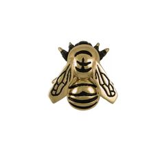 a gold and black bee ring with horns on it's head, sitting against a white background