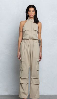 Zip-up cargo jumpsuit Halter neck Zipper closure Elastic waistband Drawstrings on leg opening Size recommendation: true to size Cargo Jumpsuit Outfit, Cargo Jumpsuit, Crazy In Love, Jumpsuit Outfit, Crazy Love, Girls Outfits, Dress Romper, Halter Neck, Zip Up