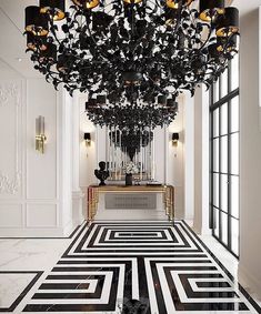 a black and white floor with a chandelier hanging from it's ceiling