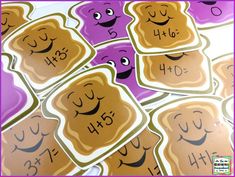 a pile of toasted bread with faces drawn on them and numbers written in the middle