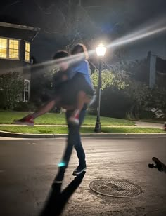 a man riding on the back of a skateboard next to a woman