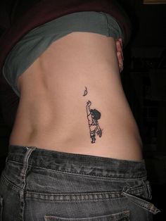 a woman's stomach with a small tattoo on her lower back and the bottom part of her belly